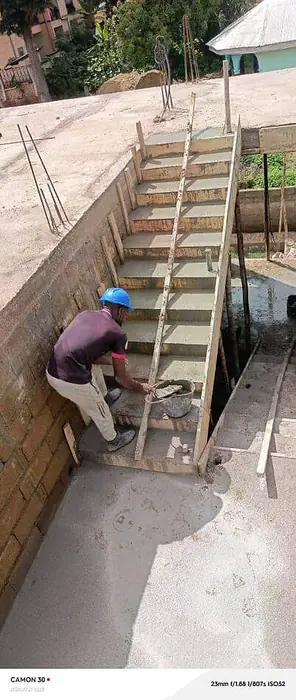 Clifton Group building construction, mason finishing concrete stairs